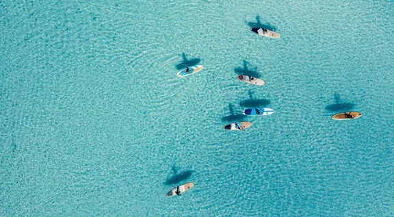Aerial view of people surfboarding at One&Only Reethi Rah