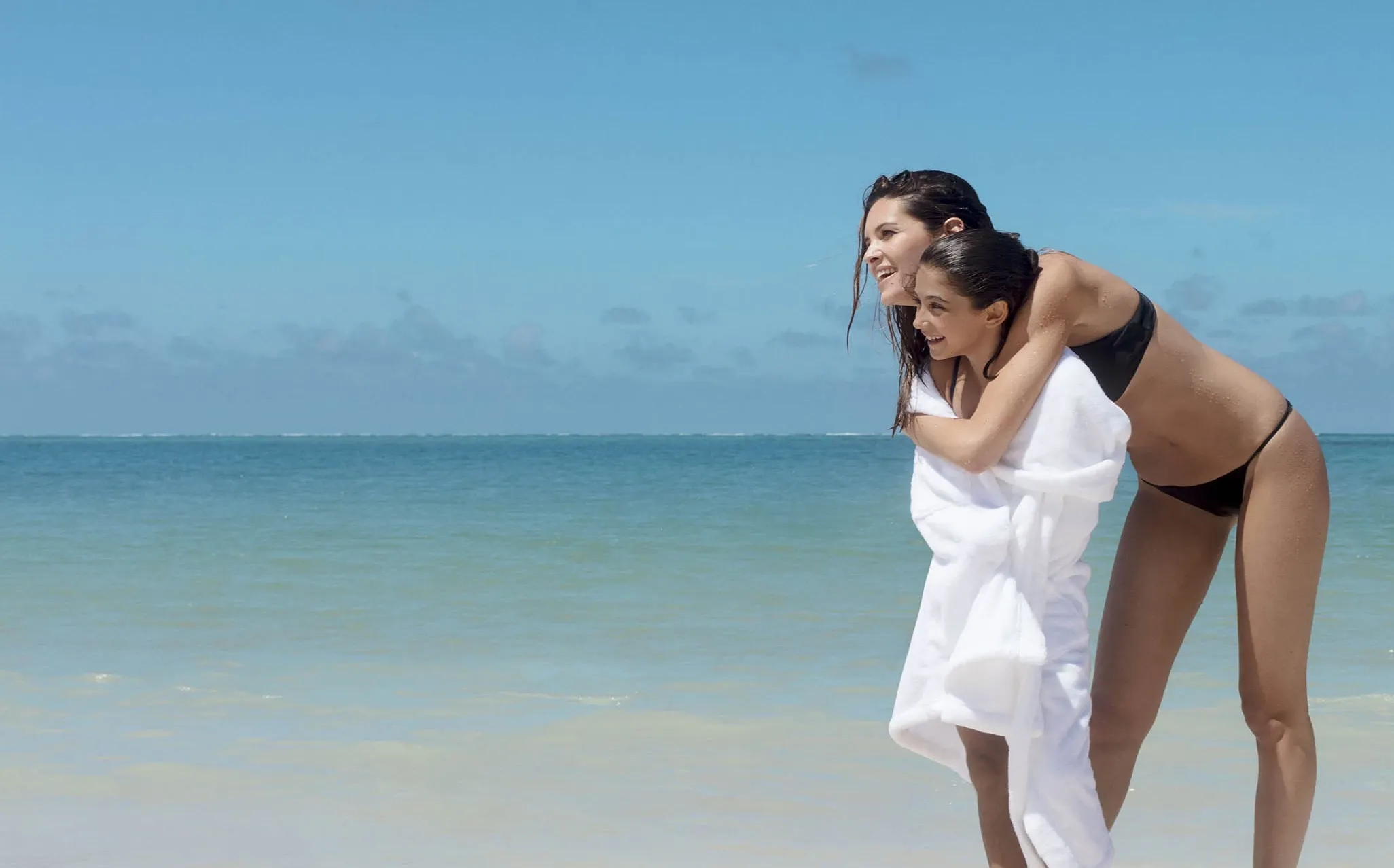 Mother & Daughter Hugging at the Beach at One&Only Le Saint Géran