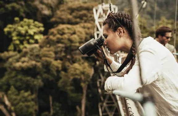 A Woman Looking through Binoculars at One&Only Nyungwe House
