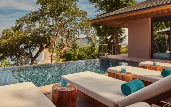 Sunbeds on the poolside at One&Only Mandarina