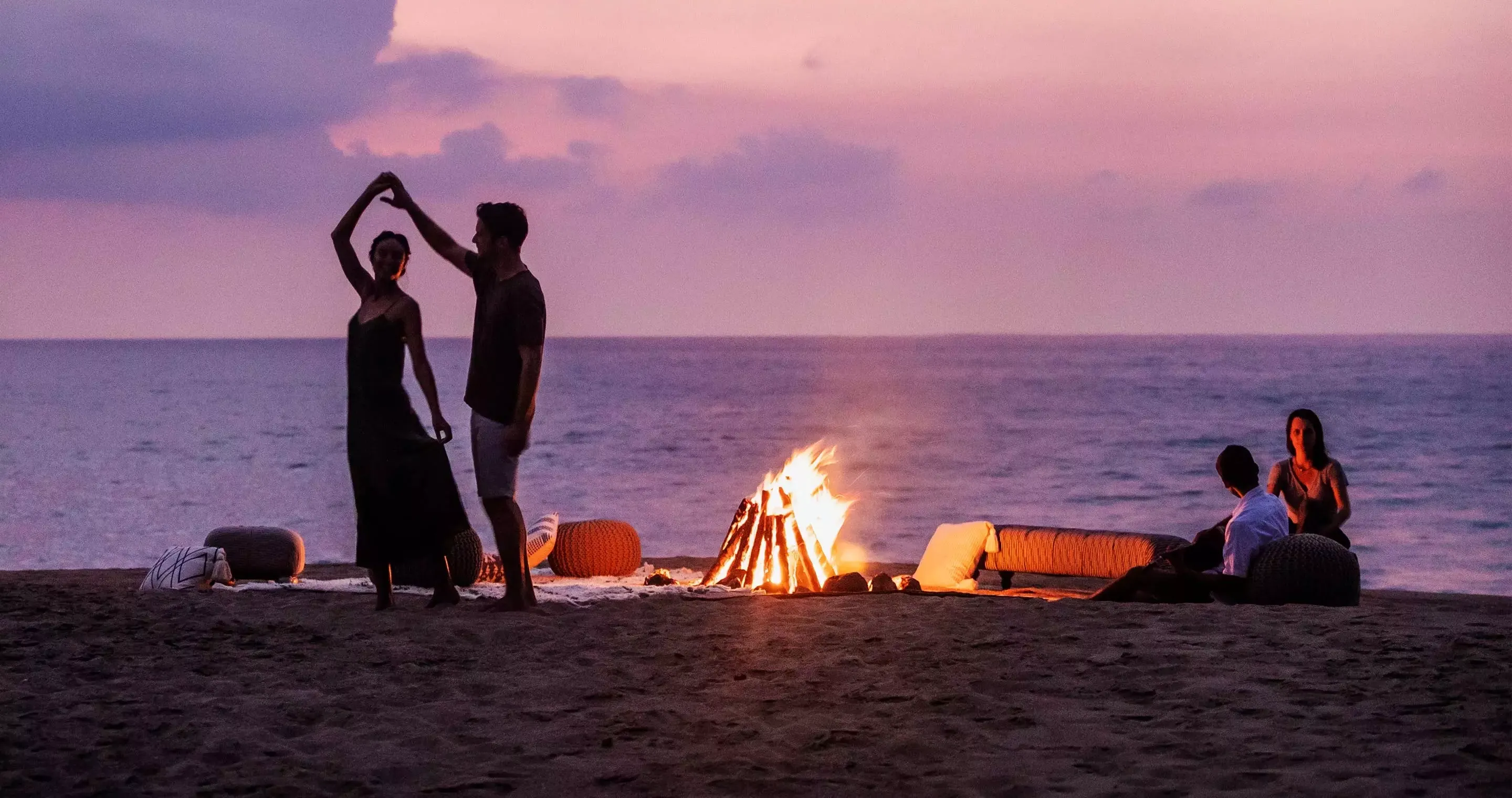 A couple dancing by the firepit at One&Only Mandarina