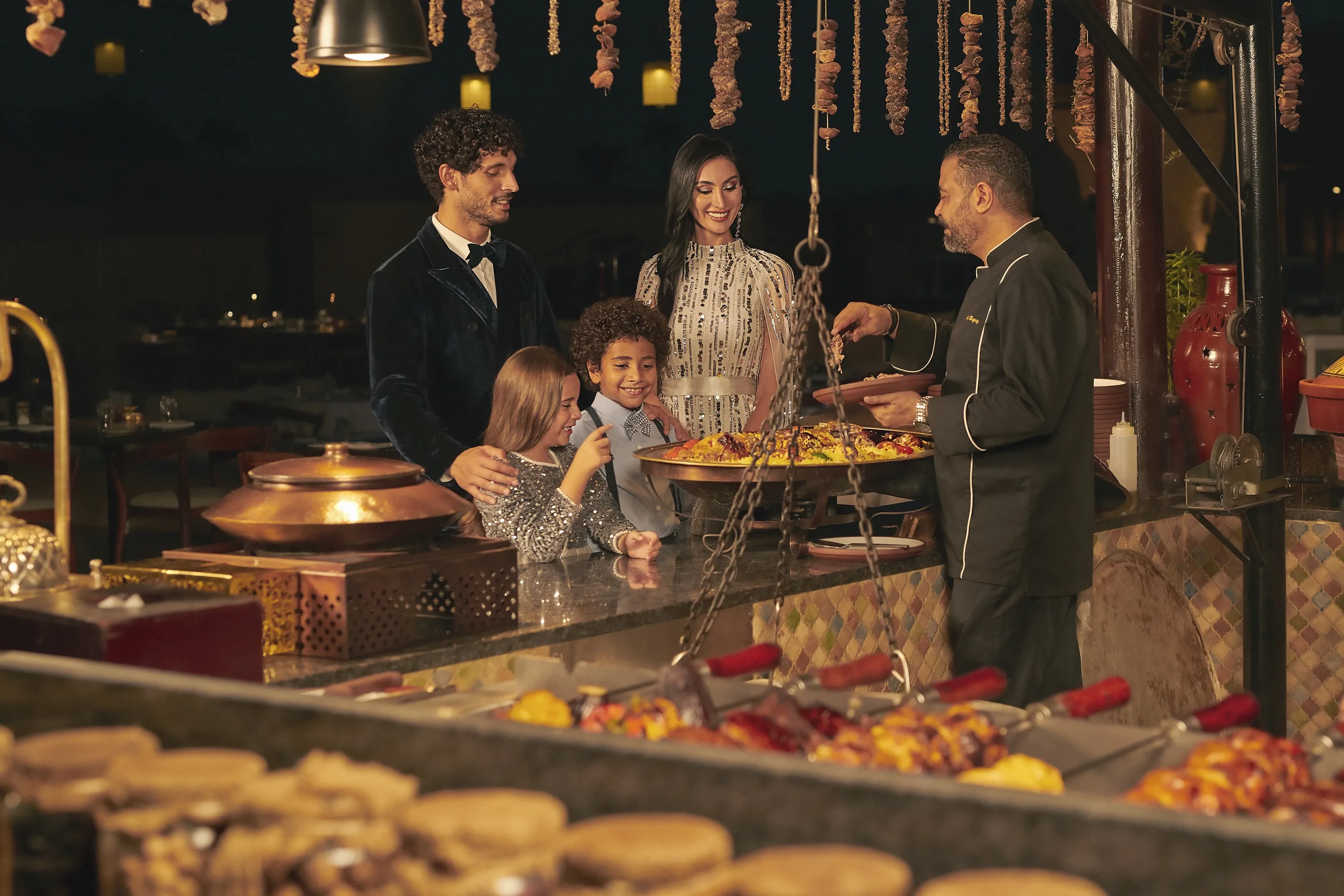 Chef serving authentic food to guests at Al Hadheerah, Bab Al Shams