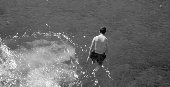 A man jumping into the sea at One&Only Aesthesis