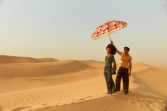 Couple walking in the desert at Bab Al Shams