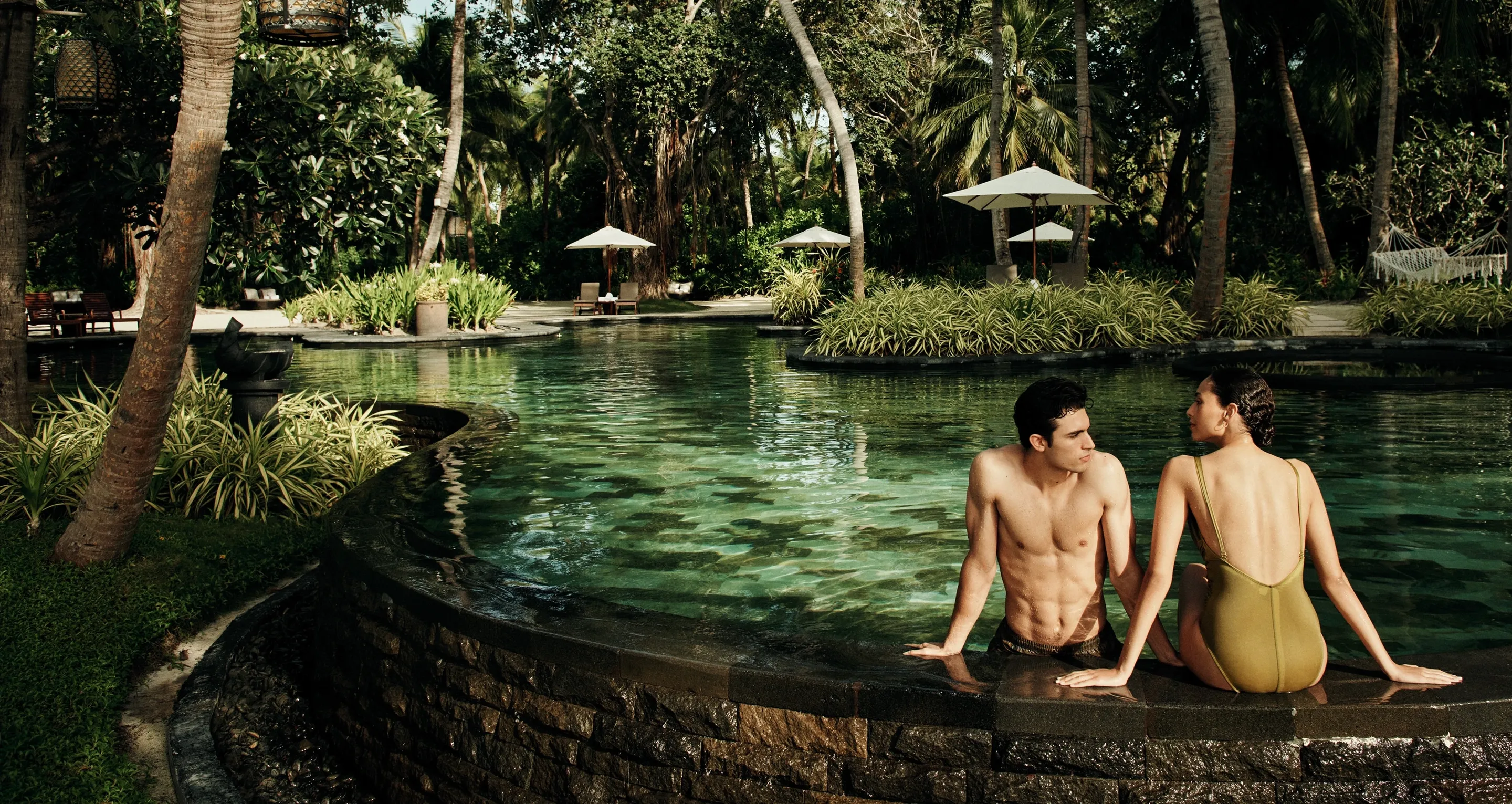 Couple in the jungle pool at One&Only Reethi Rah