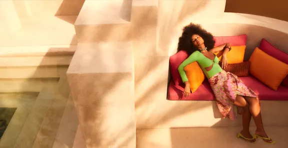 A woman relaxing on a couch at Bab Al Shams
