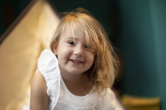 Child playing outside teepee at KidsOnly 