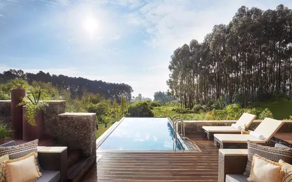 View of sunbeds on the poolside at One&Only Gorilla’s Nest