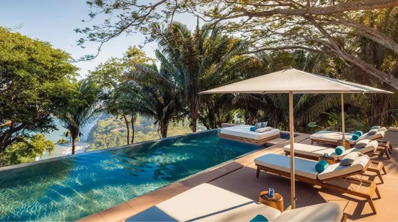 The view of sunbeds at the poolside at One&Only Mandarina Signature Villas