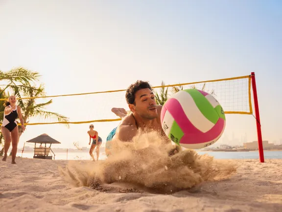 Man Playing Volleyball on the Beach