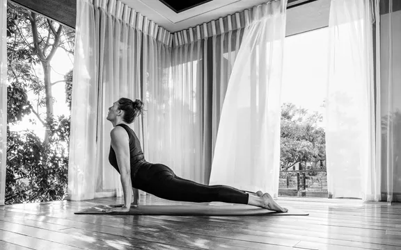 A woman practicing yoga at One&Only Cape Town